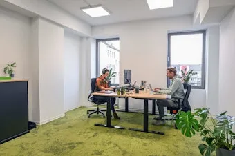 Ausgestattetes Büro mit zwei arbeitenden Personen im Coworking Space Rivvers Dortmund-CityCenter in der Dortmunder Innenstadt.